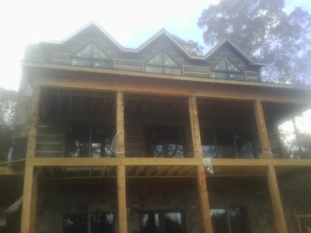 Dormers and porch framing on a large log home under construction in Mount Croghan
